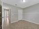 Neutral bedroom with tile flooring, bi-fold closet doors and an adjoining hallway at 3274 Hunters Chase Loop, Kissimmee, FL 34743