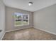 Cozy bedroom with a bright window and tile flooring at 3274 Hunters Chase Loop, Kissimmee, FL 34743