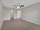 A bedroom boasts tile flooring, a ceiling fan, and arched doorway features at 3274 Hunters Chase Loop, Kissimmee, FL 34743