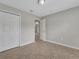 Bedroom with closet and entryway, showcasing neutral wall paint and tile flooring at 3274 Hunters Chase Loop, Kissimmee, FL 34743