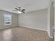 Spacious bedroom featuring a ceiling fan, tile flooring, and a large window at 3274 Hunters Chase Loop, Kissimmee, FL 34743