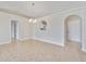 Spacious dining room featuring tile flooring, decorative archways, and a modern chandelier at 3274 Hunters Chase Loop, Kissimmee, FL 34743