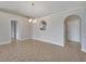 Open-concept dining area with arched doorway detail, chandelier, and tile flooring at 3274 Hunters Chase Loop, Kissimmee, FL 34743