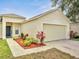 Charming home featuring a two-car garage, manicured landscaping, and a well-maintained lawn at 3274 Hunters Chase Loop, Kissimmee, FL 34743