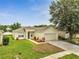 Well-maintained single-Gathering home featuring a two-car garage and a nicely landscaped front yard at 3274 Hunters Chase Loop, Kissimmee, FL 34743