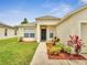 Inviting entryway of a well-maintained home with a tidy walkway, complemented by vibrant landscaping at 3274 Hunters Chase Loop, Kissimmee, FL 34743