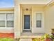 Close-up of the front door, showcasing the well-kept exterior and colorful flower bed at 3274 Hunters Chase Loop, Kissimmee, FL 34743