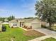 Charming single-story home featuring lush green lawn, mature landscaping, and a two-car garage at 3274 Hunters Chase Loop, Kissimmee, FL 34743