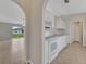 Bright eat-in kitchen featuring white cabinetry and an archway to the living area at 3274 Hunters Chase Loop, Kissimmee, FL 34743