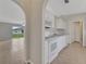 Open-concept kitchen with white cabinets and modern appliances, seamlessly flowing into the living area at 3274 Hunters Chase Loop, Kissimmee, FL 34743