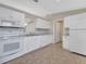 A well-lit kitchen boasts white appliances, tile flooring, and white granite countertops at 3274 Hunters Chase Loop, Kissimmee, FL 34743