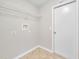 Bright laundry room with tile floors and a wire shelf for storage at 3274 Hunters Chase Loop, Kissimmee, FL 34743