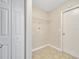 A compact laundry room has ceramic tile flooring and a single wire shelf at 3274 Hunters Chase Loop, Kissimmee, FL 34743