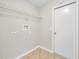 Functional laundry room with tile floors and a storage shelf at 3274 Hunters Chase Loop, Kissimmee, FL 34743