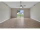 The living room features neutral paint, tile flooring, a ceiling fan and sliding glass doors leading to the backyard at 3274 Hunters Chase Loop, Kissimmee, FL 34743