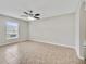 A cozy living room with natural light, tile flooring and a ceiling fan at 3274 Hunters Chase Loop, Kissimmee, FL 34743