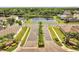 Street view of Quail Ridge community entrance with mature landscaping and a pond at 3274 Hunters Chase Loop, Kissimmee, FL 34743