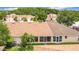 Aerial view of a well-maintained community features tidy landscaping, manicured lawns, and coordinated exteriors at 3428 Village Green Ct, St Cloud, FL 34772