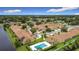 Aerial view of neighborhood homes and a community pool, with mature trees, and landscaping creating a desirable community at 3428 Village Green Ct, St Cloud, FL 34772
