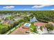 Aerial view shows a community pool, multiple homes, a lake, mature trees, and landscaping creating a desirable neighborhood at 3428 Village Green Ct, St Cloud, FL 34772