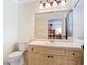 Bathroom vanity with a large mirror, a sink, and a toilet at 3428 Village Green Ct, St Cloud, FL 34772