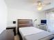 Bright bedroom with a wood frame bed, neutral walls, and a ceiling fan provides a calm and inviting atmosphere at 3428 Village Green Ct, St Cloud, FL 34772