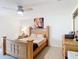 Bright bedroom with a wooden bed, side table, and dresser at 3428 Village Green Ct, St Cloud, FL 34772