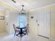 An inviting dining area features a modern light fixture and tile flooring at 3428 Village Green Ct, St Cloud, FL 34772