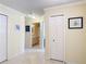 Hallway with tile flooring, framed artwork, and an adjacent bathroom at 3428 Village Green Ct, St Cloud, FL 34772