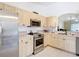 A functional kitchen features stainless steel appliances, light wood cabinets and ample counter space at 3428 Village Green Ct, St Cloud, FL 34772