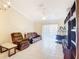 Bright living room featuring tile floors, a comfortable seating arrangement, and natural light from the sliding door at 3428 Village Green Ct, St Cloud, FL 34772