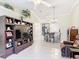 Open-concept living room featuring neutral walls, tile flooring, and views to the dining and kitchen areas at 3428 Village Green Ct, St Cloud, FL 34772
