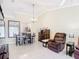 Inviting living room with tile floors, neutral walls, dining set, and comfortable seating at 3428 Village Green Ct, St Cloud, FL 34772