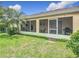Spacious screened patio with lush landscaping offers the perfect outdoor living and dining space at 3428 Village Green Ct, St Cloud, FL 34772