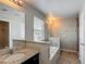 Bright bathroom features granite countertops, a tub, and a neutral color palette at 3603 Sanctuary Dr, St Cloud, FL 34769
