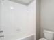 Clean bathroom with white tiled walls and a shower-tub combination at 3603 Sanctuary Dr, St Cloud, FL 34769