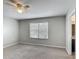 This bedroom offers a lighted ceiling fan and large window, with an entrance to the bathroom at 3603 Sanctuary Dr, St Cloud, FL 34769