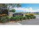 Elegant community entrance sign, 'Sanctuary', surrounded by colorful plants and manicured landscaping at 3603 Sanctuary Dr, St Cloud, FL 34769