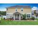 Beautiful two-story home with a covered porch and lush front yard landscaping at 3603 Sanctuary Dr, St Cloud, FL 34769