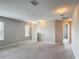 A bright living room with lots of natural light, neutral walls, and carpeted floors at 3603 Sanctuary Dr, St Cloud, FL 34769
