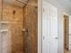 Shower room with ceramic tile and a shower head, shelves, faucet, and access to another bathroom at 3603 Sanctuary Dr, St Cloud, FL 34769
