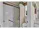 Bathroom with glass enclosed shower, white tile, and toilet at 4065 Kingsley St, Clermont, FL 34711
