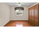 Bright bedroom features a wooden floor, neutral paint, window and a storage cabinet for your convenience at 4065 Kingsley St, Clermont, FL 34711