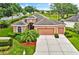 Beautiful single-Gathering home with attached two-car garage, mature landscaping, and a well-manicured lawn at 4065 Kingsley St, Clermont, FL 34711