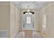 Bright foyer features neutral paint, tile floors, a decorative light fixture, and a storm door with sidelights at 4065 Kingsley St, Clermont, FL 34711