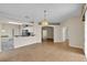 Spacious living room features tile floors, neutral paint, an elegant chandelier and an open layout to the kitchen at 4065 Kingsley St, Clermont, FL 34711