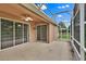Covered patio with ceiling fan and screen enclosure, offering an outdoor living space accessible through sliding glass doors at 4065 Kingsley St, Clermont, FL 34711