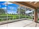 Enclosed screened porch overlooking green landscape, providing an idyllic outdoor space for entertaining and leisure at 4065 Kingsley St, Clermont, FL 34711