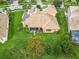 Aerial view of a private home with a tile roof, solar panels, well manicured landscaping and screened-in patio at 4109 Vessel Ct, Kissimmee, FL 34746