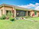 Backyard showcasing a lush lawn, meticulous landscaping, and a cozy screened-in lanai at 4109 Vessel Ct, Kissimmee, FL 34746